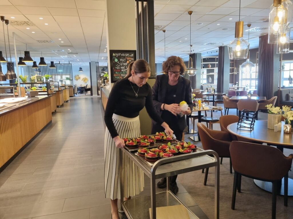 Direktør og verneombud er i gang med de siste forberedelsene før frokostgjestene kommer.